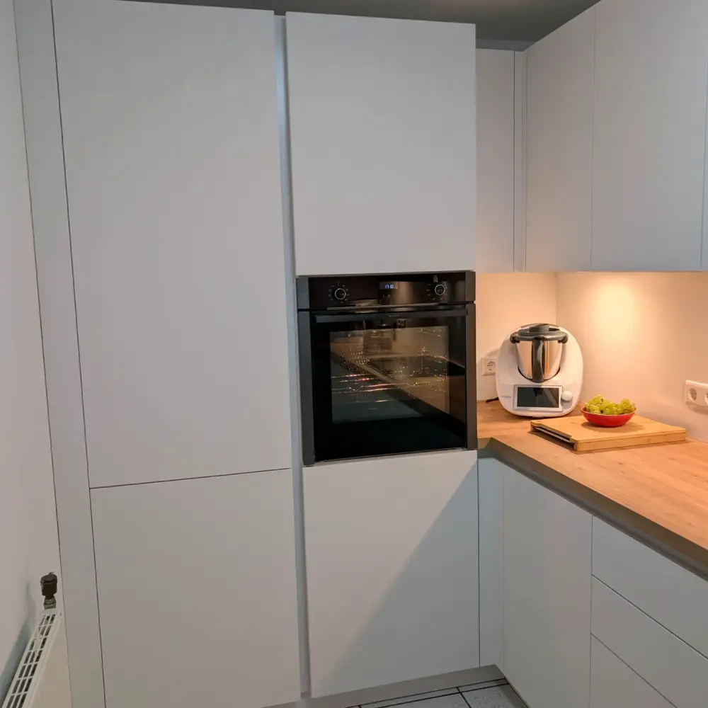 Moderne U-Küche Weiß grifflos: Hochschränke mit Backofen auf Arbeitshöhe